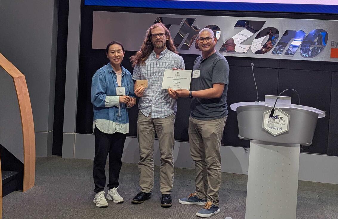 Sam receiving his a ward from the conference organizers